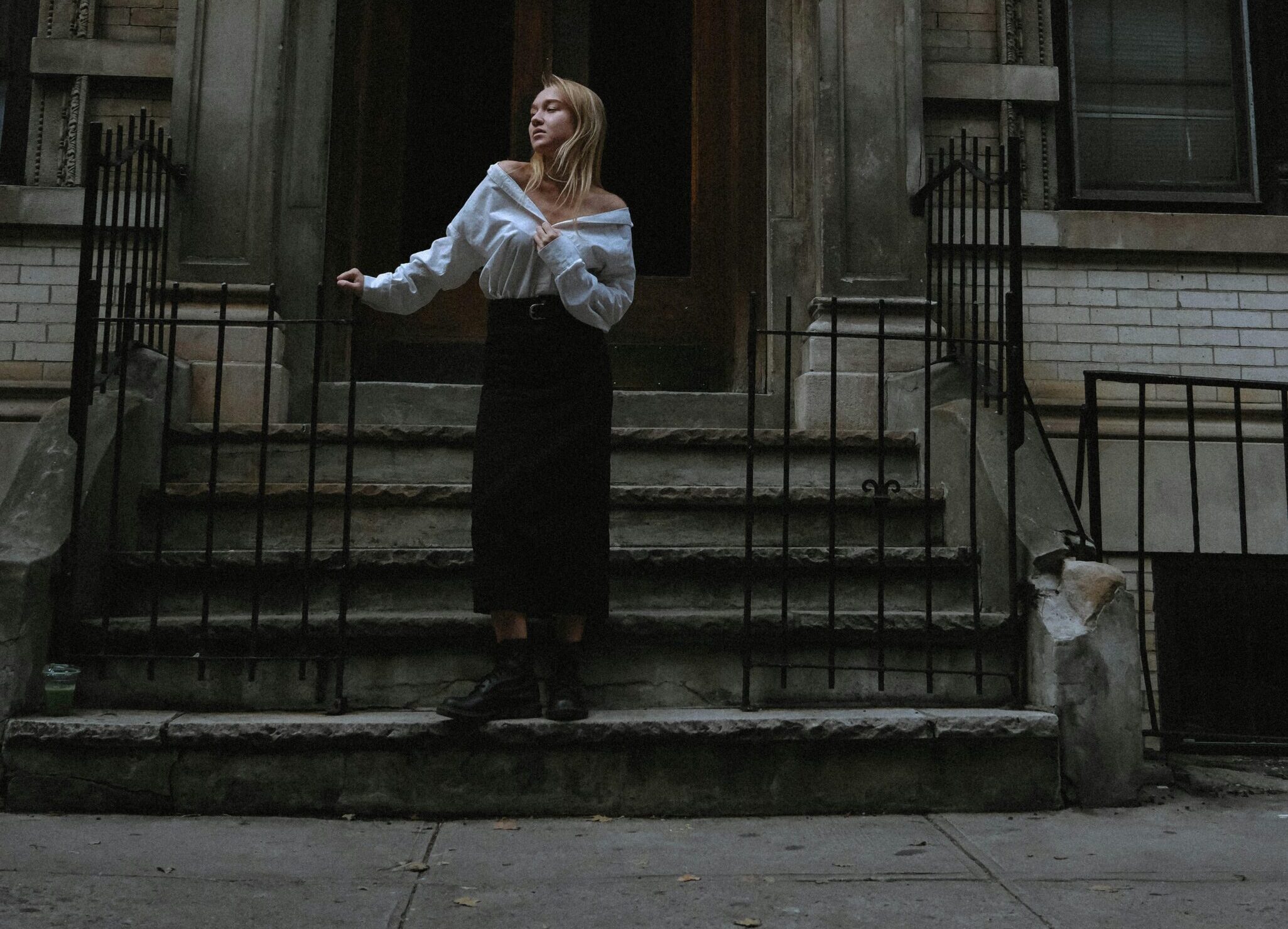 A woman standing on apartment steps