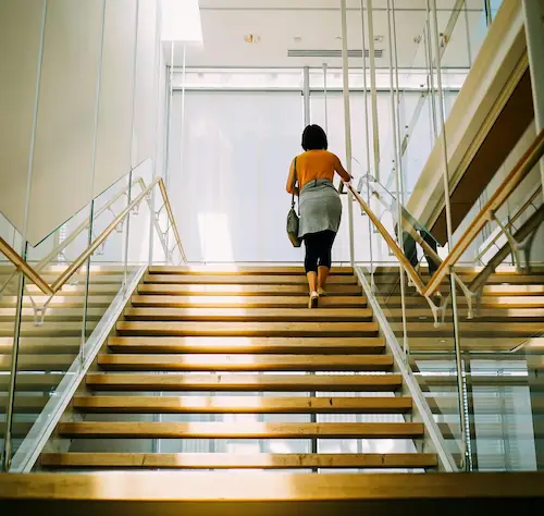 Woman walking up some stairs